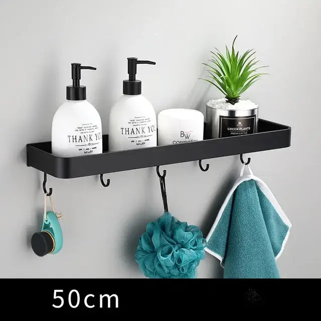 Modern matte black aluminum corner shelf with integrated hooks holding toiletries and plant for black aluminum bathroom storage