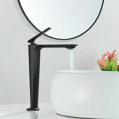 Modern matte black basin mixer with sleek angular design and tall spout flowing water into white ceramic sink decorbites black basin