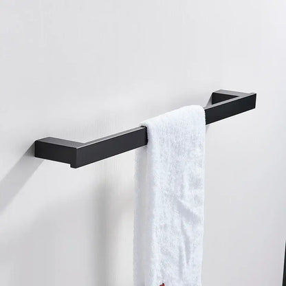 Modern matte black bathroom hardware set featuring a square black matte metal towel rack with a white terry cloth towel