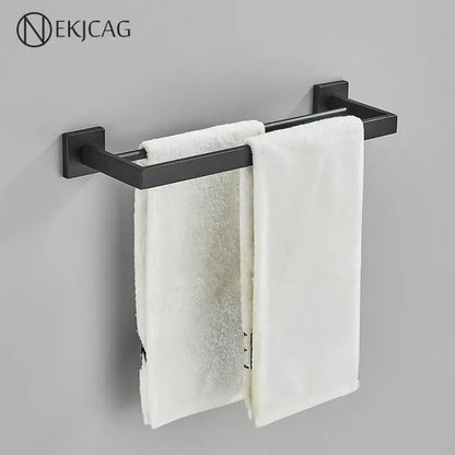Modern matte black bathroom set featuring a decorbites black bathroom matte metal towel rack with two white towels hanging