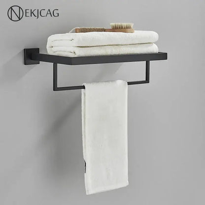 Black metal wall-mounted towel rack with flat shelf and white towels from modern matte black bathroom set decorbites black bathroom