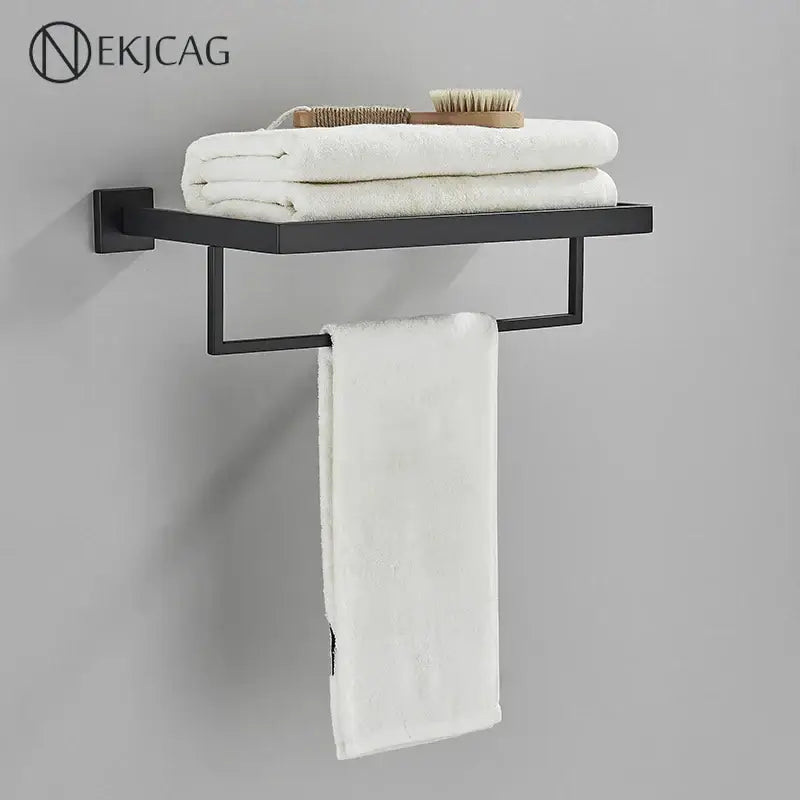 Black metal wall-mounted towel rack with flat shelf and white towels from modern matte black bathroom set decorbites black bathroom