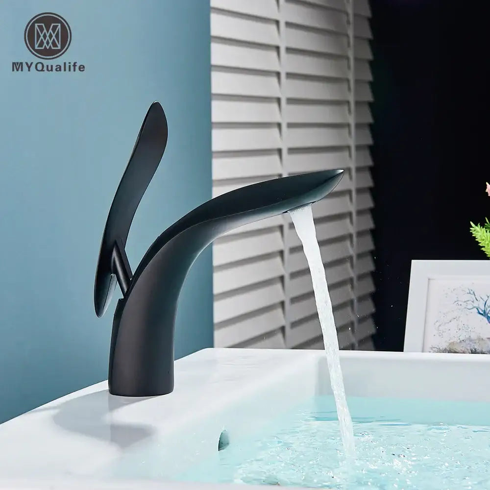 Modern matte black brass washbasin faucet by decorbites with sleek curved design and single handle for bathroom use