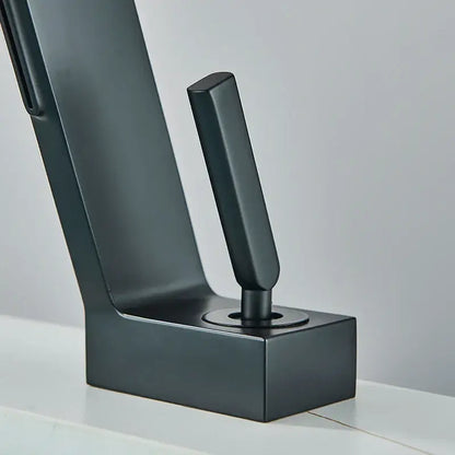 Modern matte black brass waterfall basin faucet with sleek minimalist design and rectangular spout for bathroom use
