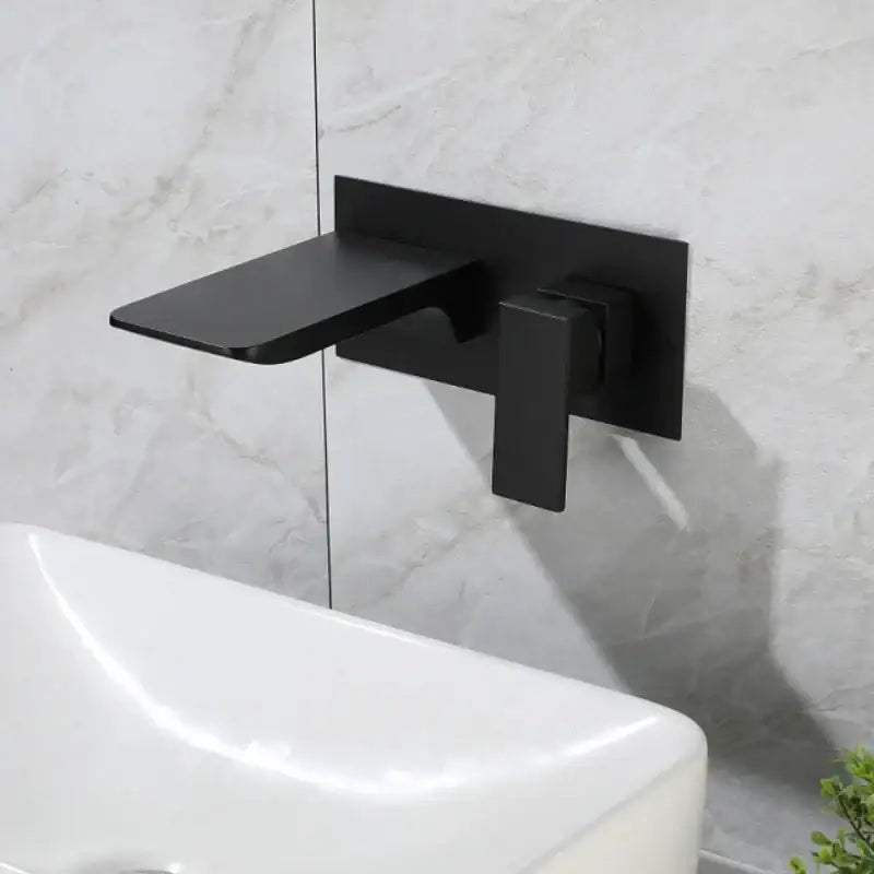 Black matte wall-mounted basin faucet with sleek modern design made of solid brass and brushed gold accents