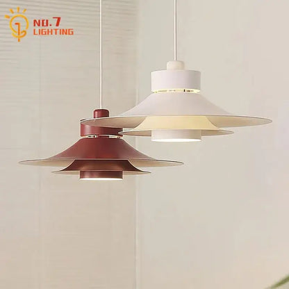 Modern matte black flying saucer pendant light with white and terracotta tiered shades and sleek metal accents for dining room decorbites modern flying