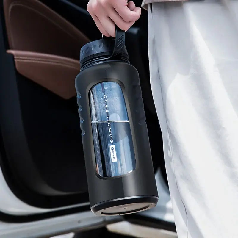 Modern matte black insulated glass water bottle with textured grip and clear window branded classic mug for drinkware