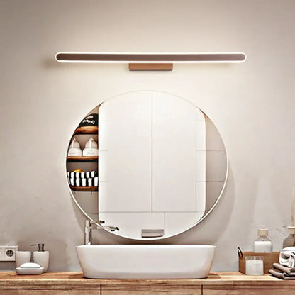 Modern round medicine cabinet with wooden shelves mounted above a sink illuminated by a matte black linear led vanity sconce