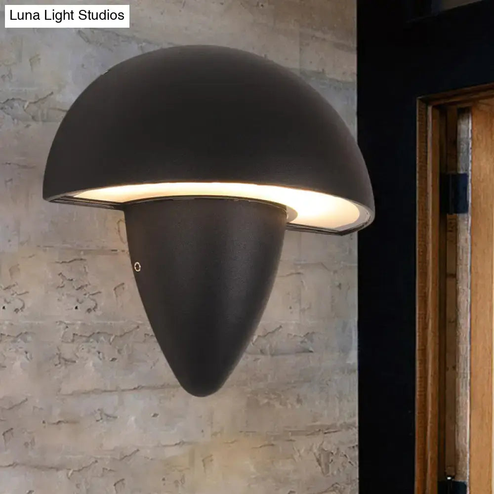 Modern matte black mushroom led wall sconce with warm glowing light diffused through curved underside porch light