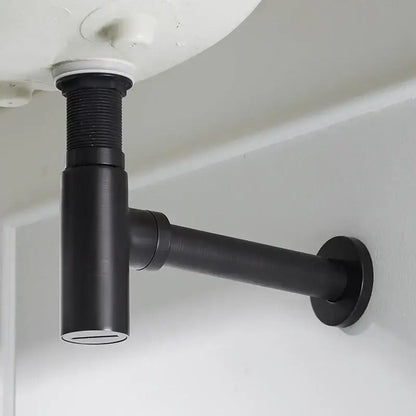 Modern matte black round bottle trap with black matte-finished under-sink drain pipe and threaded connection seen from back side