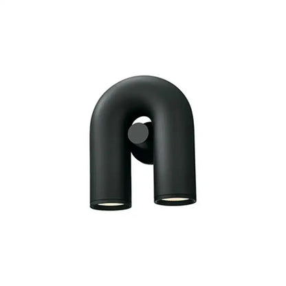 Modern matte black u-shaped wall lamp with silver tube fixtures designed as a decorbites cirkus tube bedroom sconce