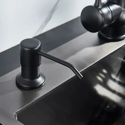 Modern matte black soap dispenser with stainless steel head and curved spout for kitchen use