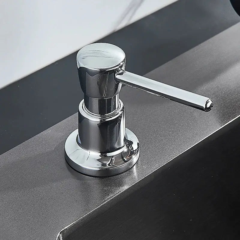 Modern matte black soap dispenser with chrome-finished stainless steel head and long horizontal pump handle for kitchen use
