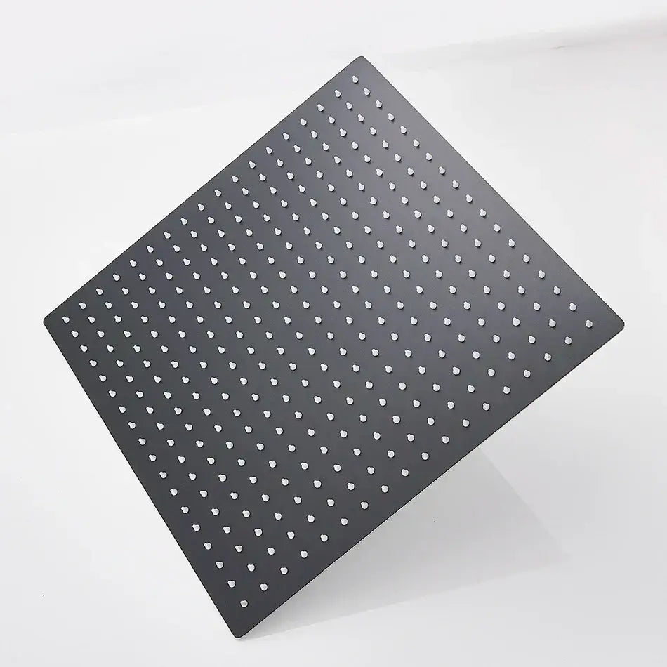 Black square metal rainfall shower head with evenly spaced white circular holes and modern matte finish