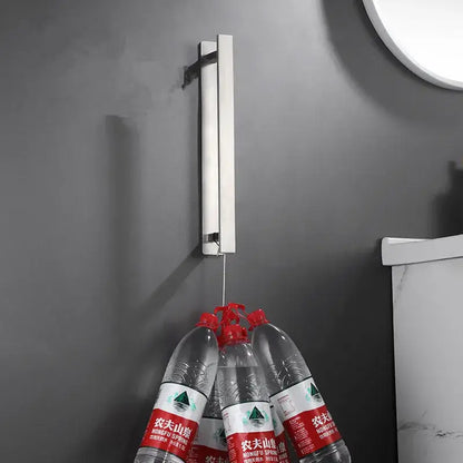Silver metallic wall-mounted towel rack with sleek minimalist design holding clear bottles by decorbites black steel