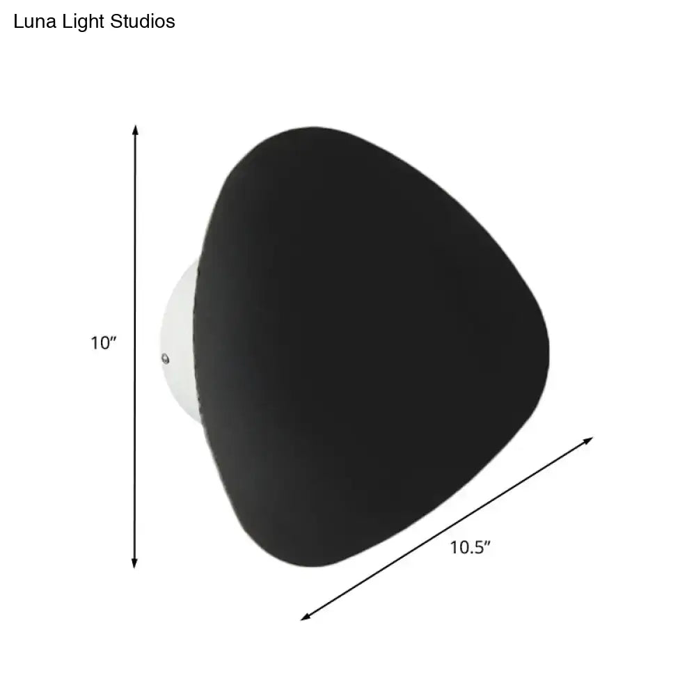 Modern matte black triangle wall lamp with a white mounting base designed for corridor lighting