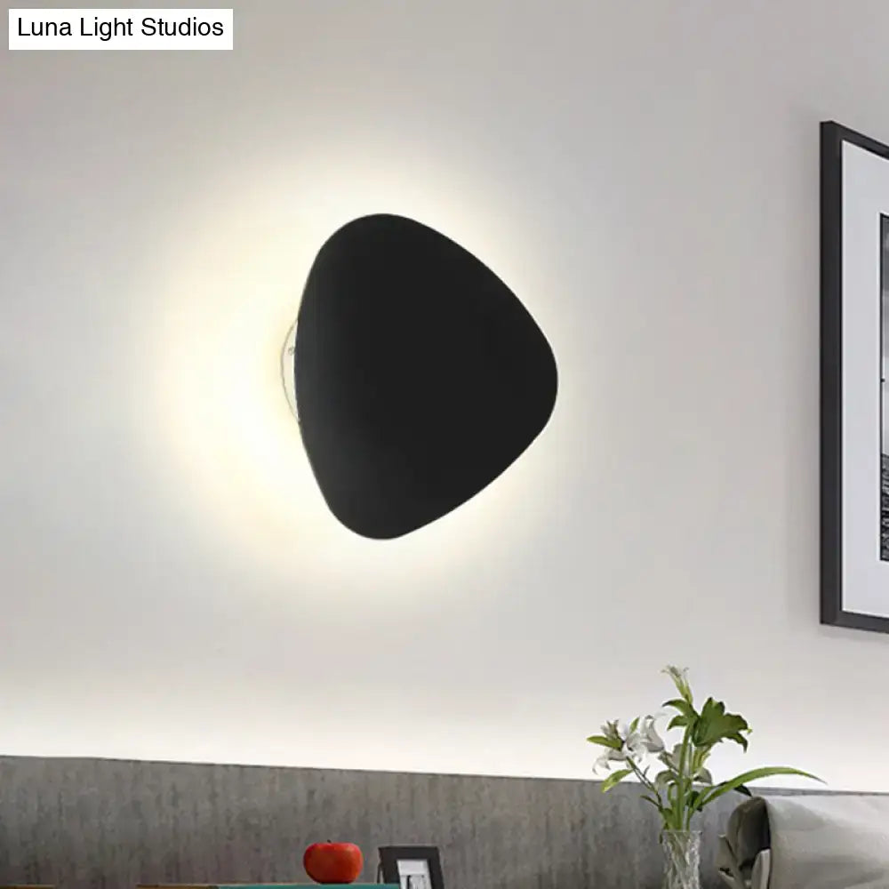 Modern matte black triangle wall lamp with a sleek finish designed for corridor lighting