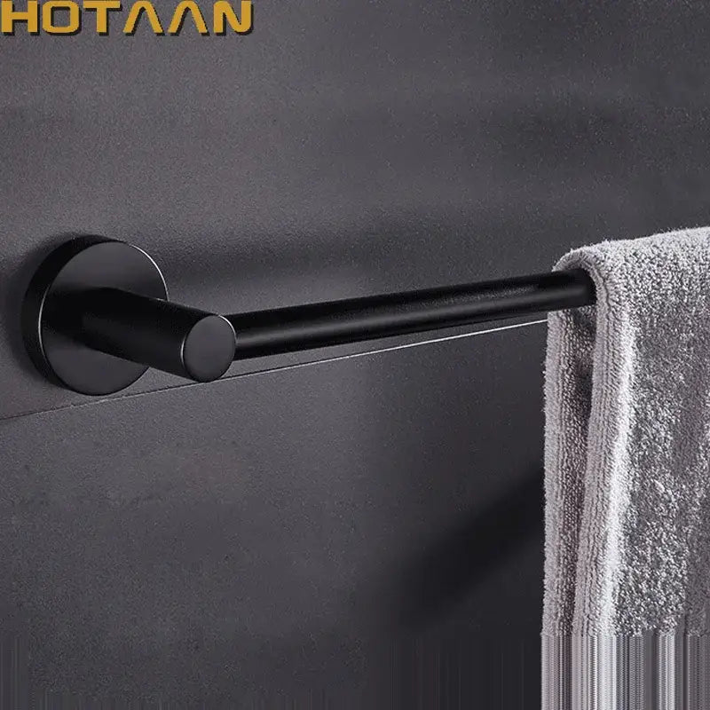 Modern matte black wall mounted towel bar with wood accents featuring a sleek black matte wall towel rack design