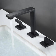 Modern matte black waterfall basin faucet with three square handles and a sleek rectangular spout for bathroom decorbites brushed gold style