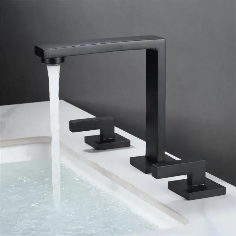 Modern matte black waterfall basin faucet with three square handles and a rectangular spout for bathroom decorbites brushed gold style