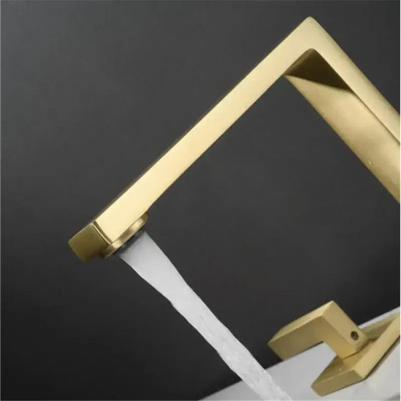 Modern brushed gold basin faucet with sleek angular design and flowing water stream for bathroom decorbites brushed gold
