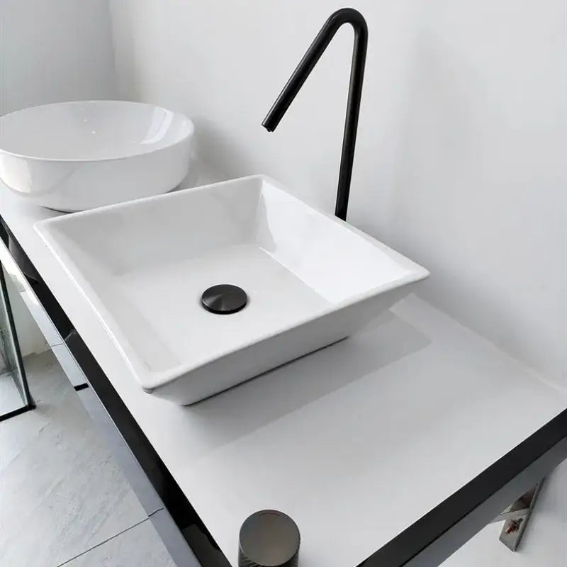 White square ceramic sink with a modern decorbites brushed black basin faucet and matte black drain for bathroom use