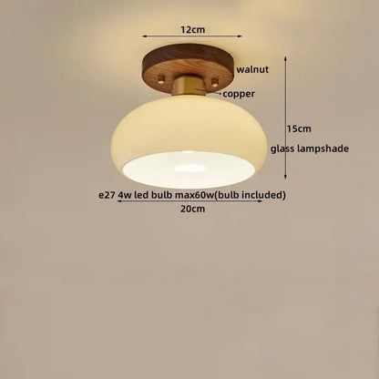 Rounded glass ceiling lamp with warm glow, mounted on walnut wood base and copper decorbites led wood canopy
