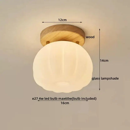 A warm glowing spherical glass ceiling lamp with subtle ribbed texture and decorbites led wood canopy base