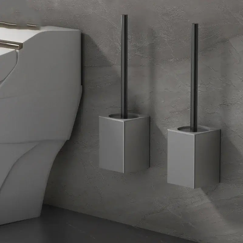 Modern matte gray and black metal toilet brush holder set with sleek cylindrical brush for bathroom use