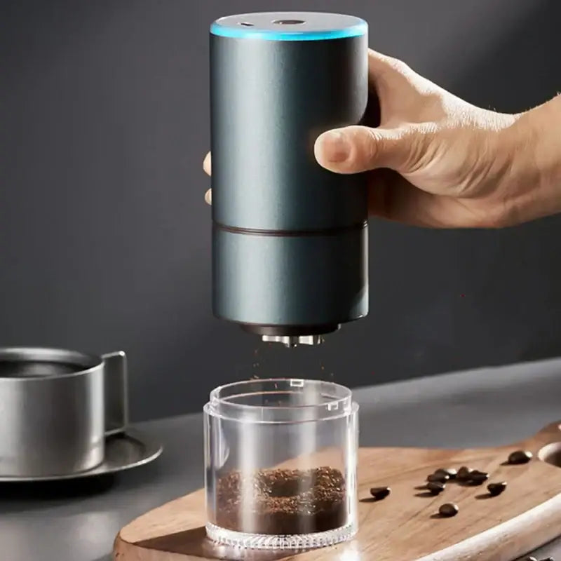 Modern matte gray electric bean grinder with dark gray cylindrical body and blue light ring for kitchen coffee use