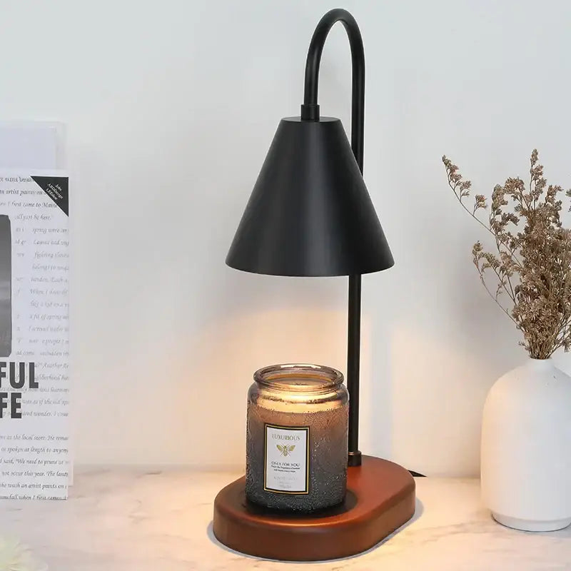 Black metal electric candle lamp warmer with curved arm conical shade wooden base and amber luxurious glass jar