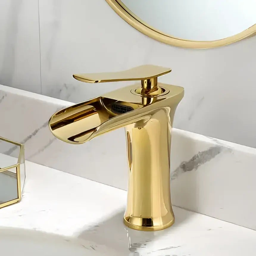 Gold-finished basin faucet with a single handle and sleek modern grey waterfall brass design for bathroom sink decorbites
