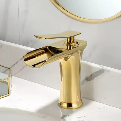 Gold-finished basin faucet with a single handle and sleek modern grey waterfall brass design for bathroom sink decorbites