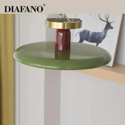 Diafano pendant ceiling light with glossy olive green shade and polished brass top fixture for modern living room use