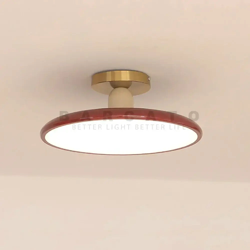 Modern matte white and brass led ceiling light with a glossy red rim and warm white illumination for living room