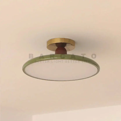 Modern olive green led ceiling light with brass mounting ring and wooden stem for living room illumination
