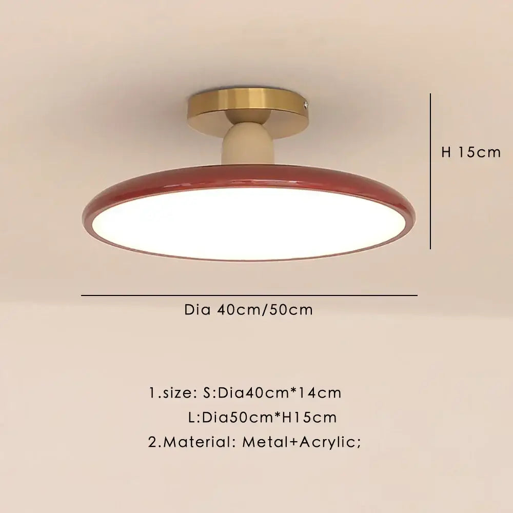 Modern matte white and brass led ceiling light with red-rimmed circular design and acrylic diffuser for living room