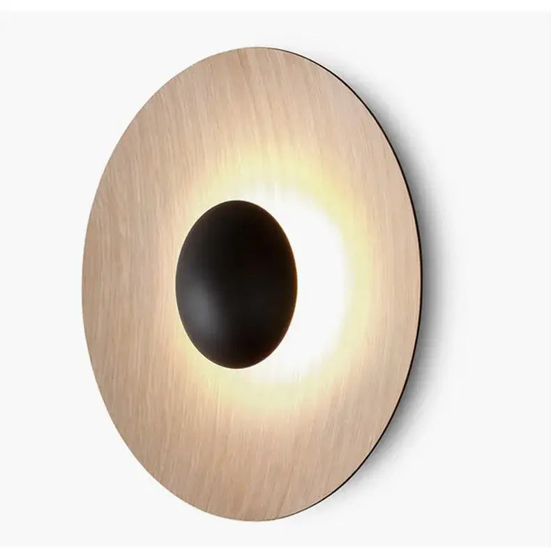 Modern matte white and brushed bronze ginger round wall lamp with circular brushed gold frame and black oval light fixture