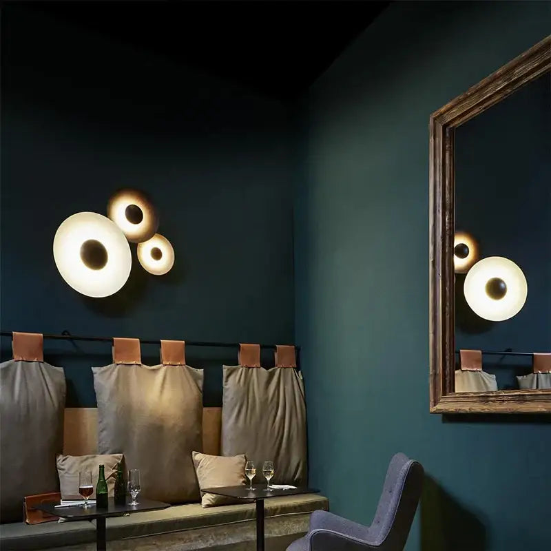 Modern matte white and brushed bronze decorbites ginger round wall lamp with warm glowing light for bedroom decor