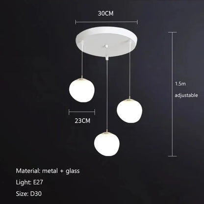 Modern matte white glass pendant light with three spherical globes and metal hardware for kitchen or dining decorbites gregg glass pendant