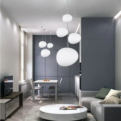 Modern matte white glass pendant light with spherical design hanging in minimalist kitchen and dining room decorbites gregg glass pendant