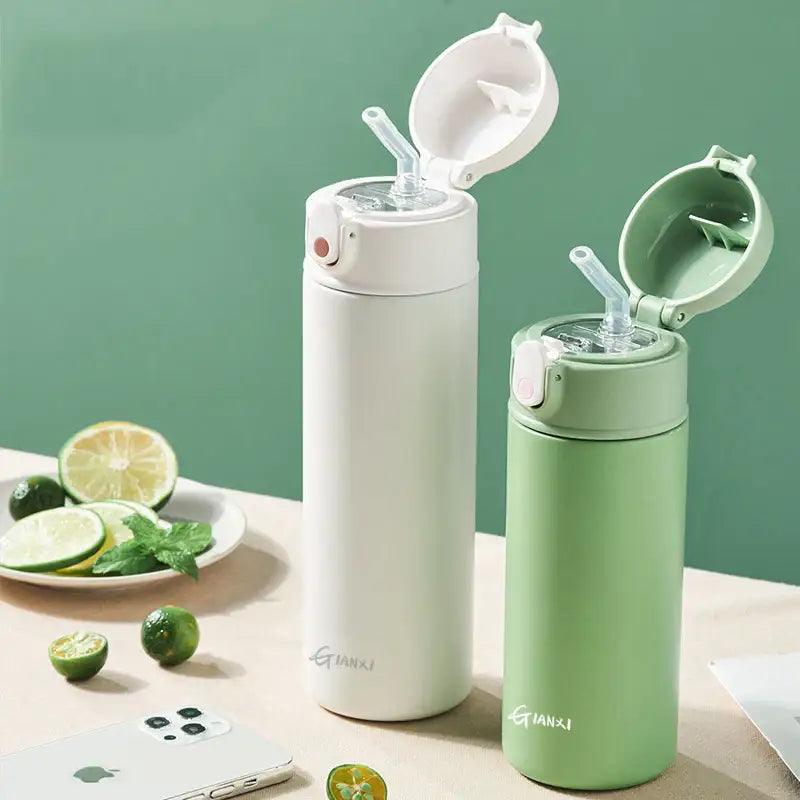 Two sleek stainless steel decorbites insulated thermos bottles in matte white and mint green with flip-top lids and straws