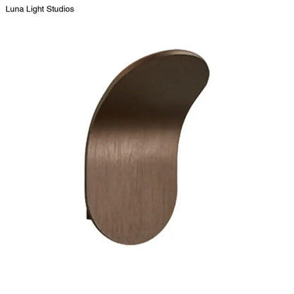A sleek curved wall light with a brushed bronze metal bracket in black gold coffee finish for bedroom use