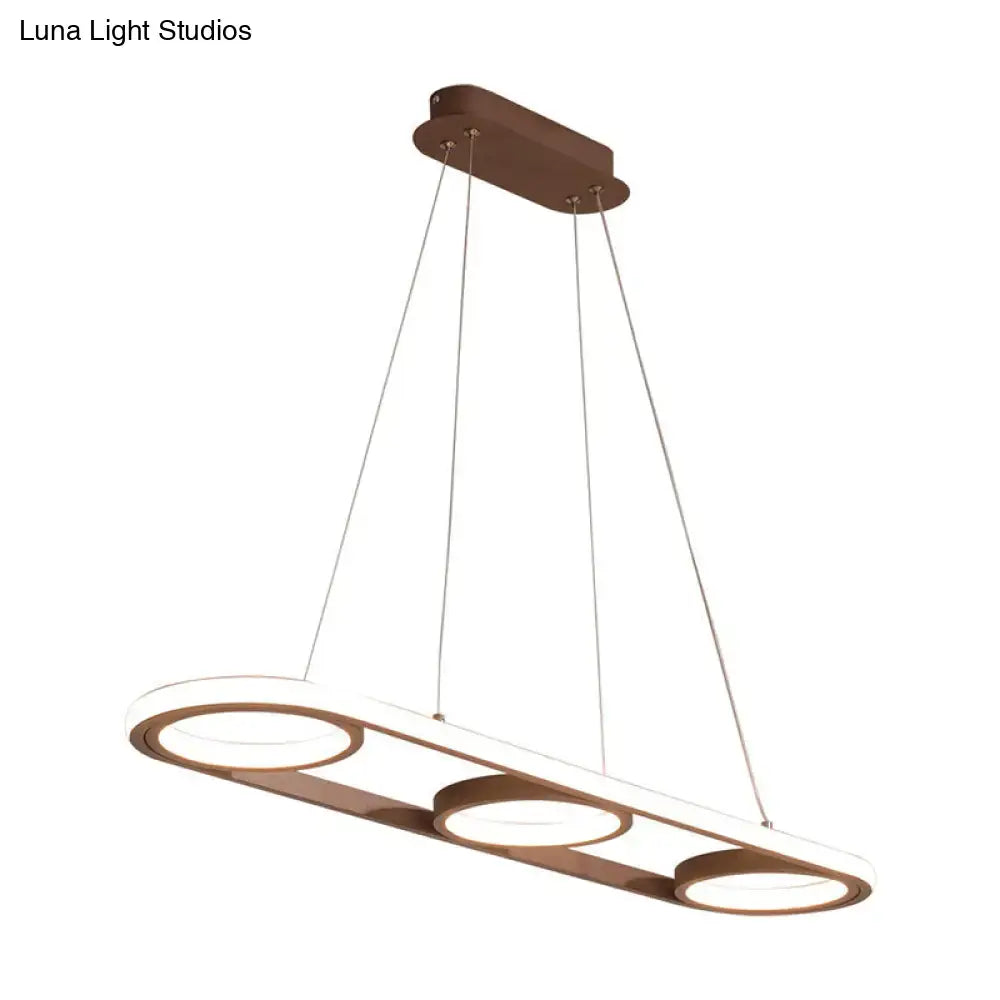Modern metal white oval pendant light with bronze finish and three circular led rings for kitchen island illumination