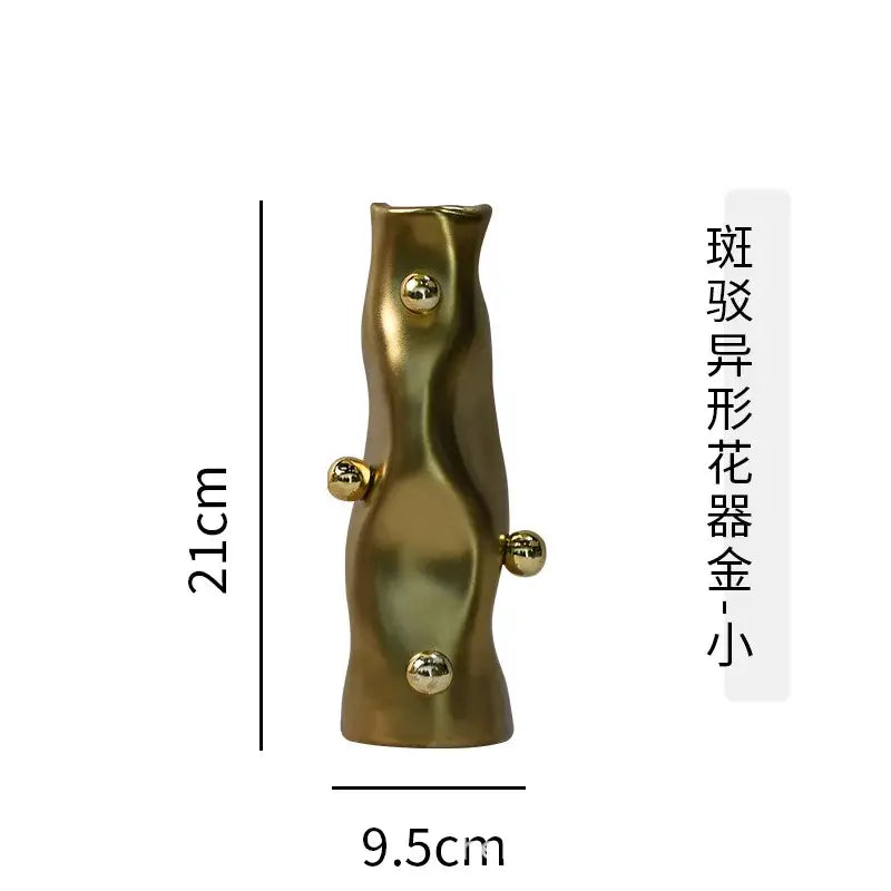 A sleek 21cm tall gold-toned ceramic decorbites geometric sphere vase with wavy form and polished metallic spheres