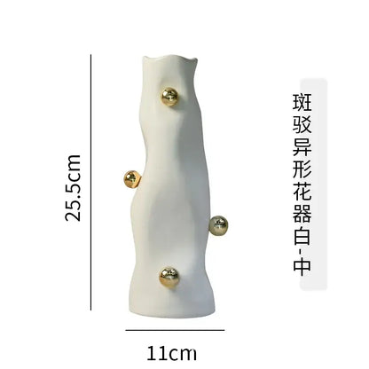 A sleek white ceramic geometric sphere vase with four polished gold accents from decorbites geometric sphere set