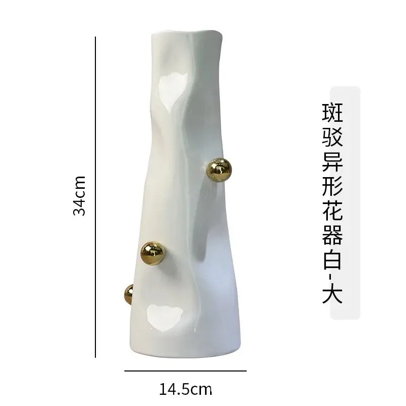 A tall white ceramic decorbites geometric sphere vase with sculpted organic form and three gold sphere accents for living room