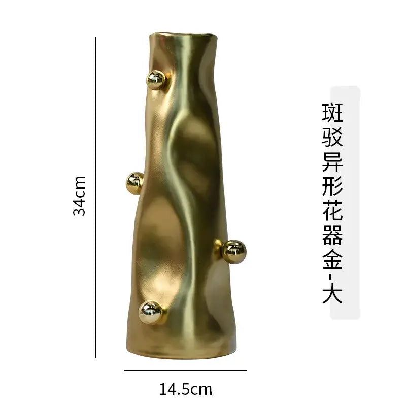 A tall sculpted gold decorbites geometric sphere vase with wavy texture and four metallic spheres for modern living rooms