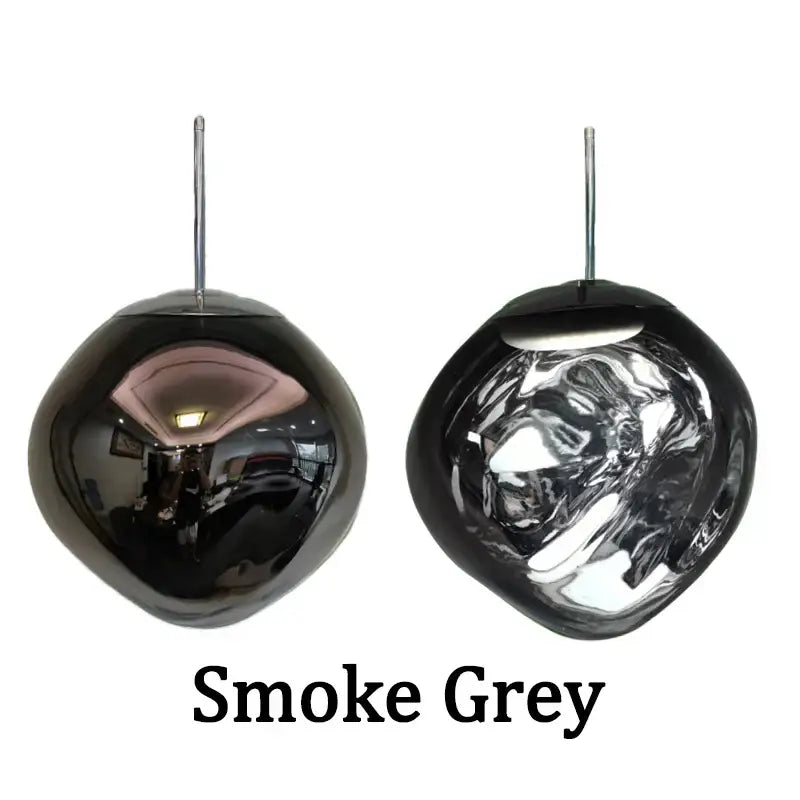 Modern metallic glass pendant lights featuring smoke grey rounded glass pendant lights with reflective surfaces in a dining room cluster fixture