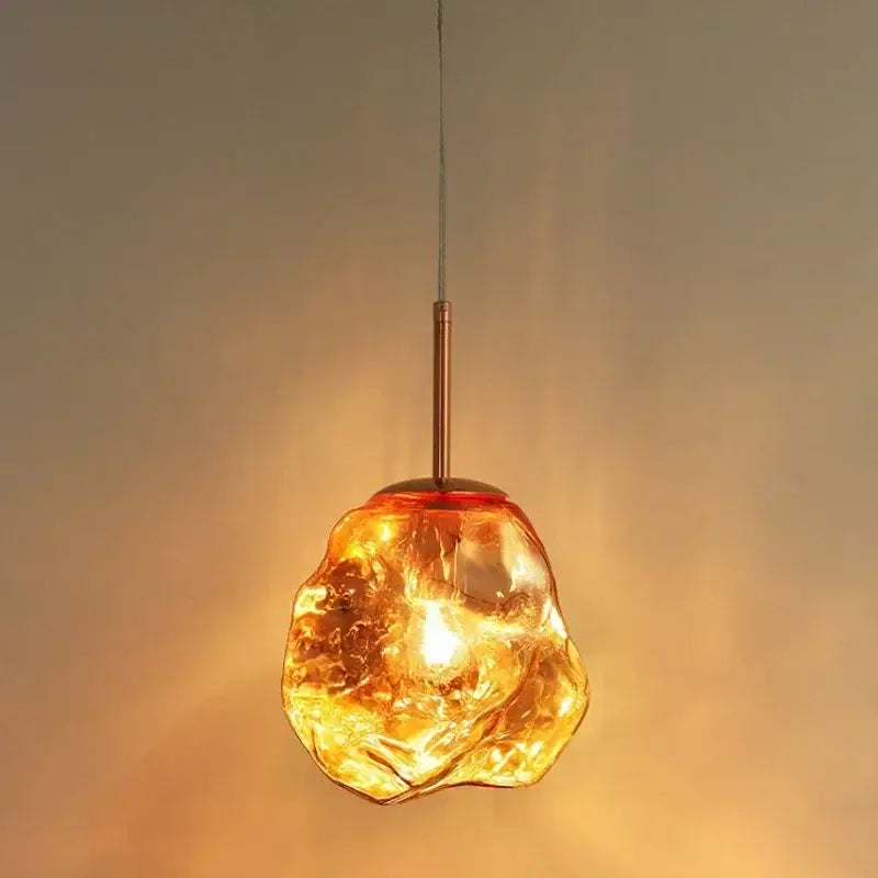 Warm amber glass pendant light with textured organic shape and copper stem for modern decorbites ice glass pendant